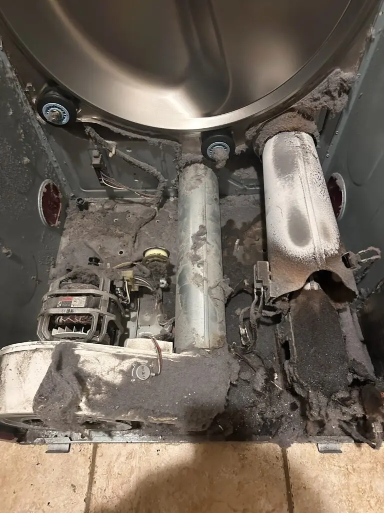 Dryer with lint buildup behind the drum