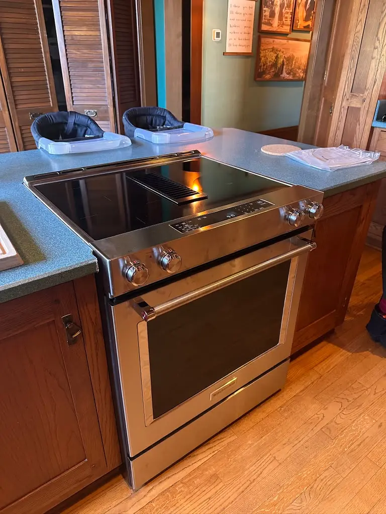 Slide-in range with a glass cooktop in a home kitchen