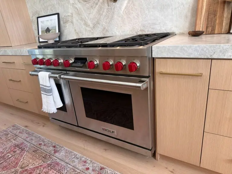 Wolf range with red knobs in a home kitchen